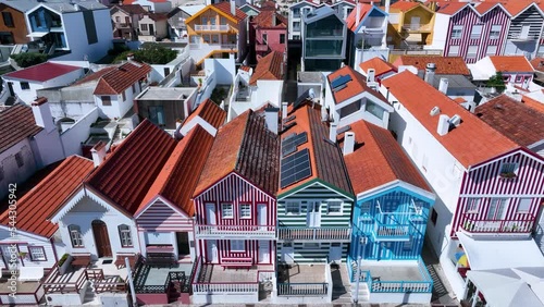 Colored houses on the beach of Costa Nova on the shore of the Ria de Aveiro on the Atlantic coast of Portugal. It belongs to the city of Ilhavo. Aerial view from a drone. Portugal. Europe