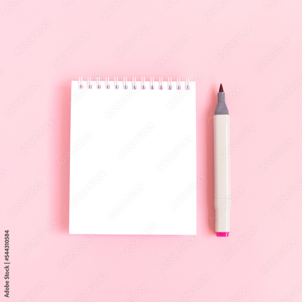 Clean notepad mockup and felt tip pen on a pink pastel background. Empty notebook template. Clean notepad mockup and felt tip pen on a pink pastel background. Empty notebook template.