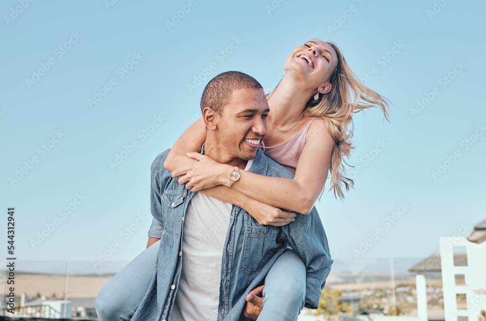 Naklejka premium Interracial, couple and piggy back with outdoor fun of a happy girlfriend and boyfriend feeling love. Happiness of a woman and man together for anniversary or engagement announcement with a smile