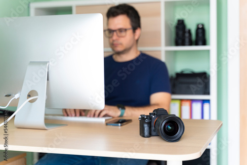Photographer in his office working on the computer