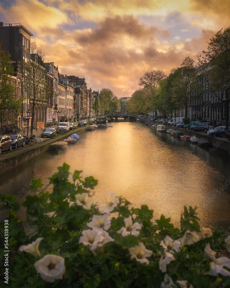 Water Canal With Boats At Sunset In Amsterdam Netherlands