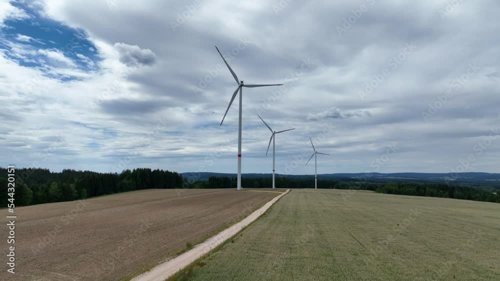 Windmills in Countryside Landscape Aerial View of Wind Turbines Under Cloudy Sky Windmills in Countryside Landscape Aerial View of Wind Turbines Under Cloudy Sky