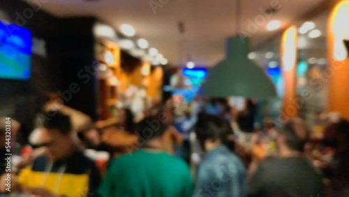 Wallpaper Mural many people eat snacks and drink socializing, talking and enjoying inside a busy bar with music at the end of the work week at night, unfocused blocked shot, Ordes, Galicia, Spain Torontodigital.ca