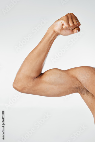 Fitness, muscle and arm bicep in studio, isolated on white background for exercise, workout and training. Strength, power and strong body of muscular man flexing for bodybuilding, gym and wellness