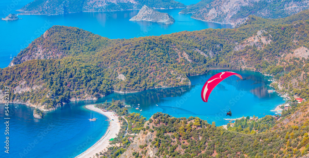 Paraglider flies in the sky -Panoramic view of Oludeniz Beach And Blue Lagoon, Oludeniz beach is best beaches in Turkey - Fethiye, Turkey