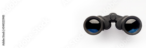 Binoculars on a light white background. Banner. Flat lay, top view