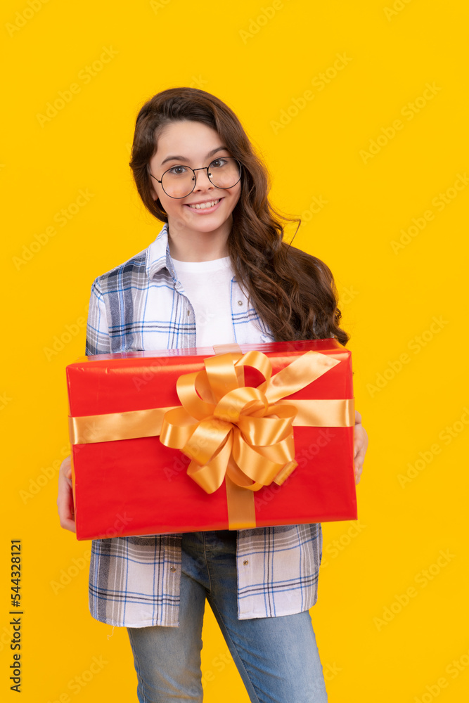 studio shot of smiling teen child hold present. teen child holding box of present. teen child studio shot of smiling teen child hold present. teen child holding box of present. teen child