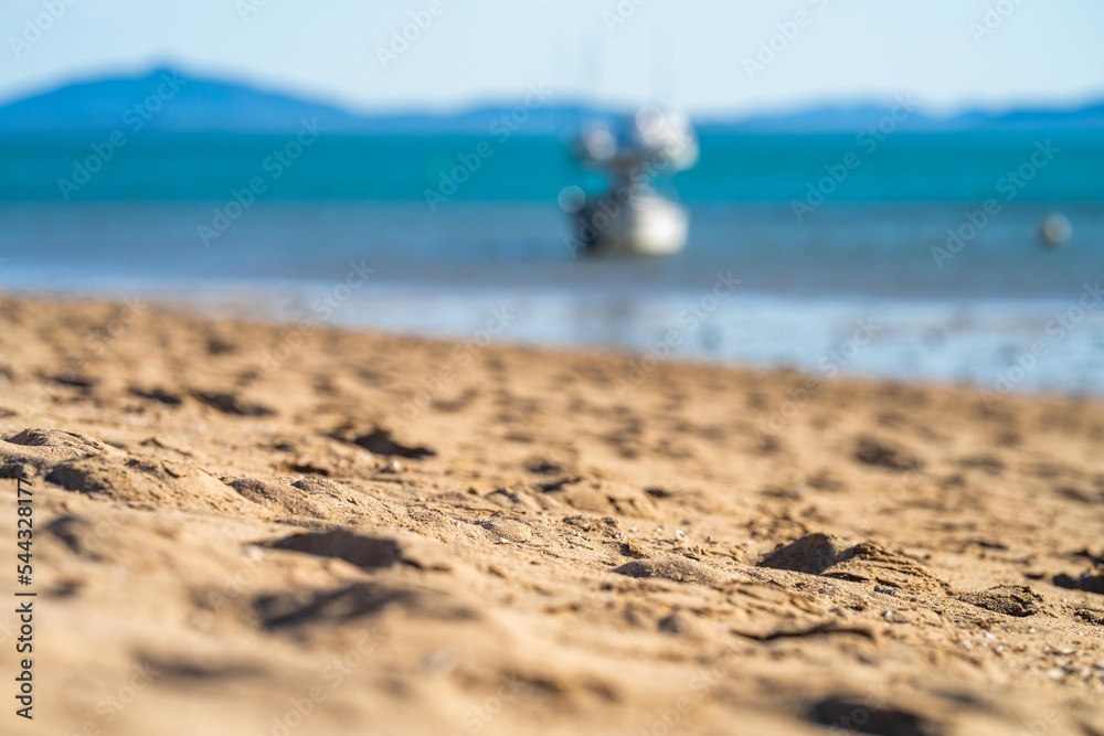 tourists on holiday at a tropical beach in the tropics with boats and yachts tourists on holiday at a tropical beach in the tropics with boats and yachts