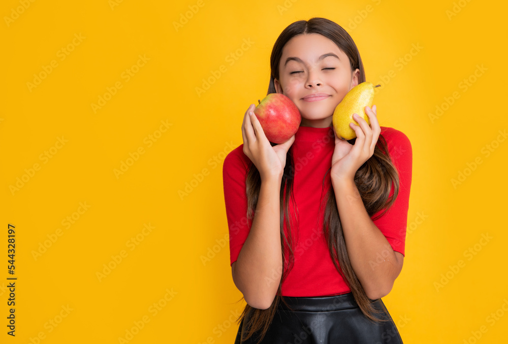 cheerful kid hold fresh apple and pear on yellow background cheerful kid hold fresh apple and pear on yellow background