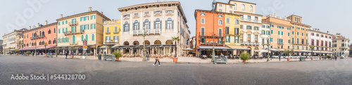 Extra wide view of The beautiful Square Brà in Verona with houses with colored facades © Alessio