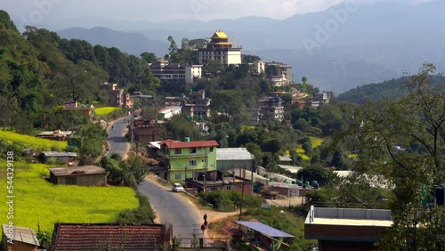 A view of the Neydo Tashi Choling Monastery in the small town of Dakshinkali in Nepal surrounded with mustard fields. photo
