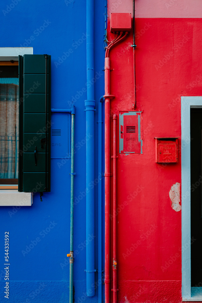 Detail on houses colored blue and red in Burano