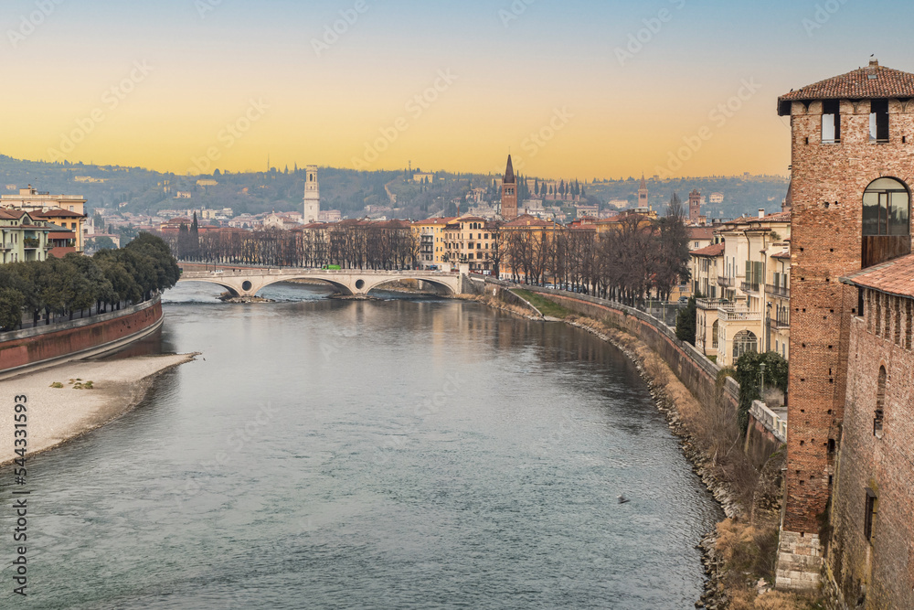 The Adige river and the panorama of Verona seen from the Castelvecchio bridge at sunset