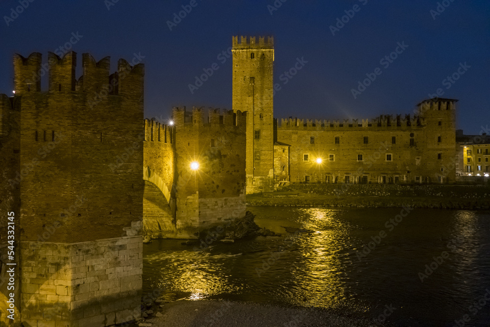 The Castelvecchio in Verona and the Adige River illuminated at night