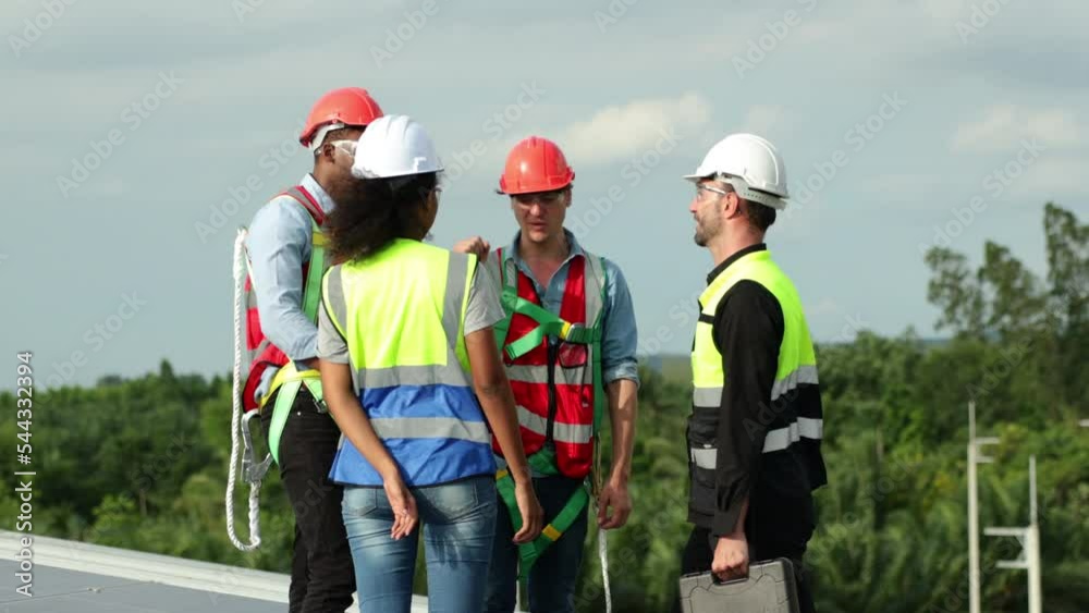 Ethnic diversity worker people, Success teamwork. Group of professional electrician engineering people wearing hardhat safety helmet meeting with solar photovoltaic panels discussion in new project Ethnic diversity worker people, Success teamwork. Group of professional electrician engineering people wearing hardhat safety helmet meeting with solar photovoltaic panels discussion in new project