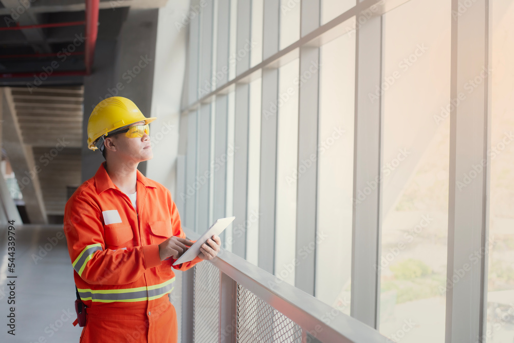 Engineer or foreman holding tablet . job details Engineering site and working with technology concept. Engineer or foreman holding tablet . job details Engineering site and working with technology concept.