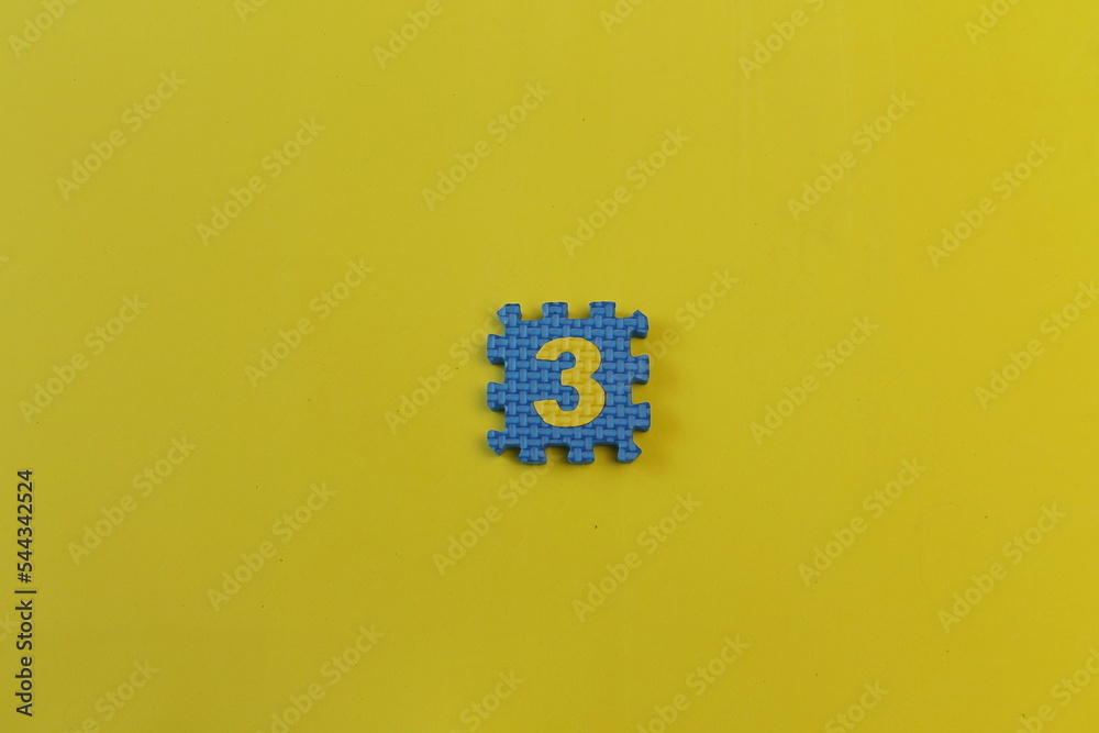 one puzzle on a yellow background, the number three one puzzle on a yellow background, the number three