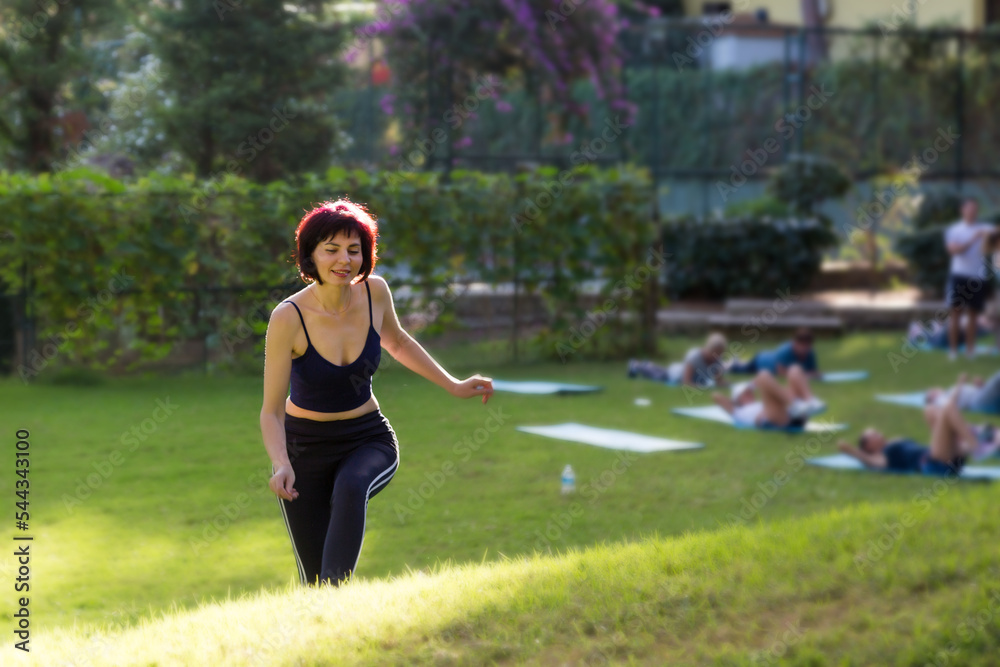 Beautiful woman walking grass after yoga class.