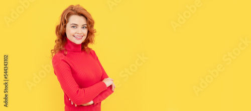 beautiful redhead girl face portrait smiling on yellow background, copy space, fashion