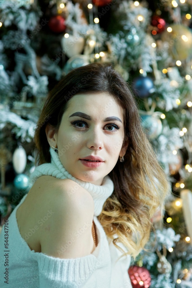 A girl in a beautiful room decorated for the holiday. The concept of Christmas and New Year holidays. A girl in a beautiful room decorated for the holiday. The concept of Christmas and New Year holidays.