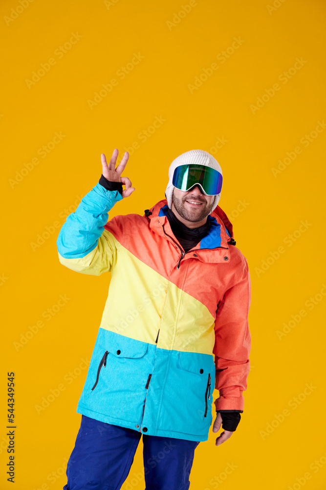 man with snowboard goggles doing an ok with his hand man with snowboard goggles doing an ok with his hand