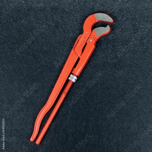 Pipe wrench on black background