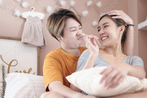 Asian lesbian couple  LGBTQ. Happy Two young Asia women showing love and romance together at home. Positive mood and moment of LGBT lesbian.