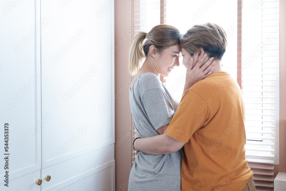 Fototapeta premium Asian lesbian couple, LGBTQ. Happy Two young Asia women showing love and romance together at home. Positive mood and moment of LGBT lesbian.