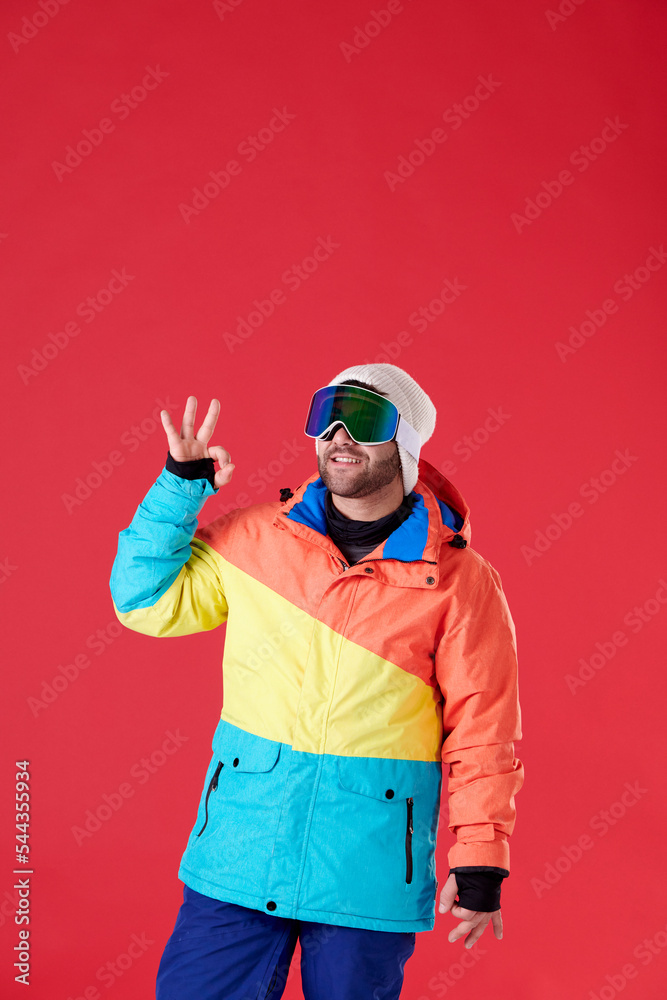 man with snowboard goggles doing an ok with his hand man with snowboard goggles doing an ok with his hand