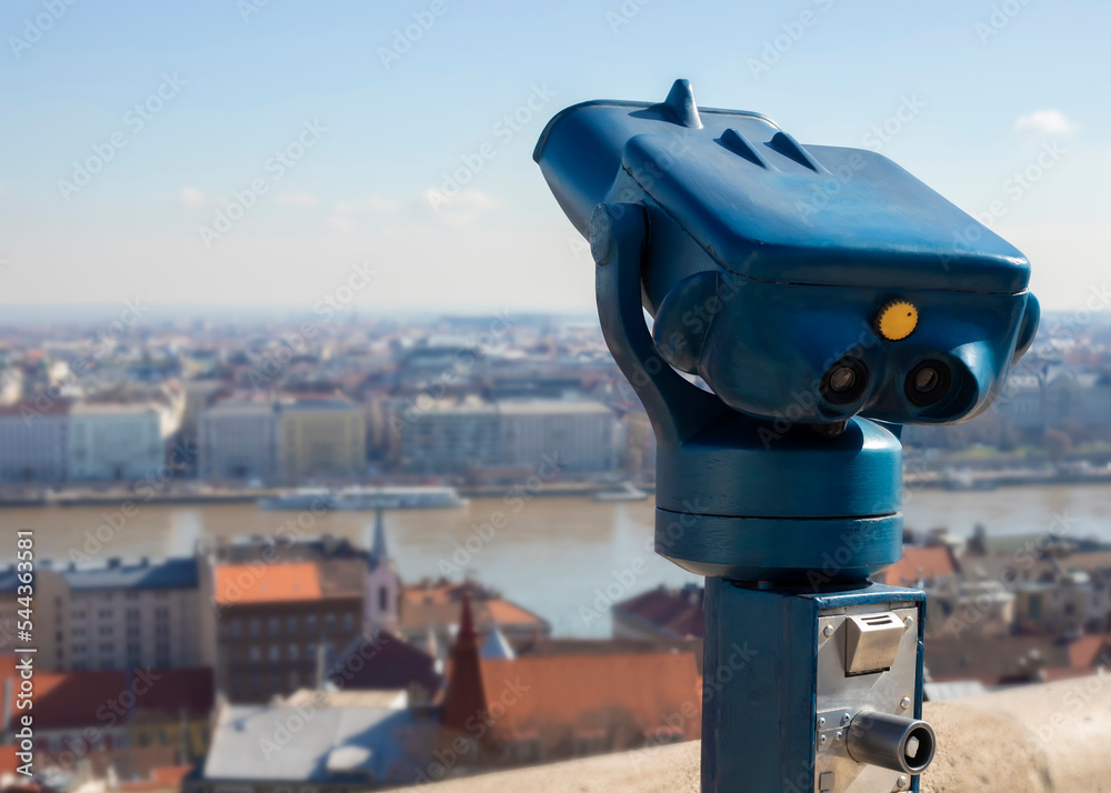 Touristic telescope look at the city view of Budapest, close up old metal binoculars overlooking the city Touristic telescope look at the city view of Budapest, close up old metal binoculars overlooking the city