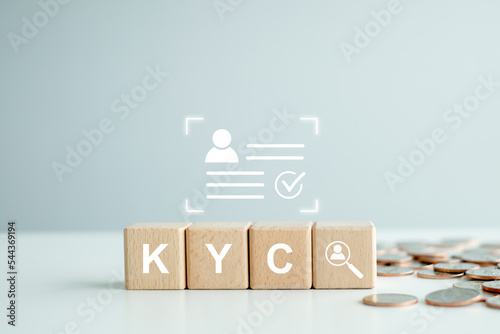 KYC on wooden cubes. know your customer with magnifying glass and customer information. Business verifying the identity of its clients concept. photo