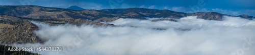 Above the clouds flowing through the mountain valley