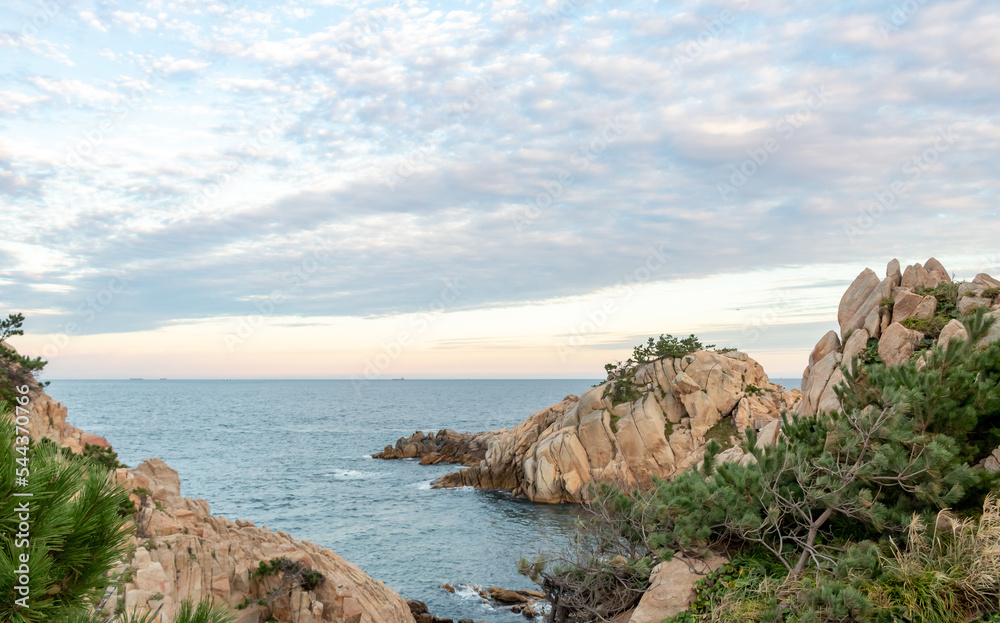 Red rocky coastline overlooking the ocean at Daewangam Park in Ulsan South Korea during a sunset