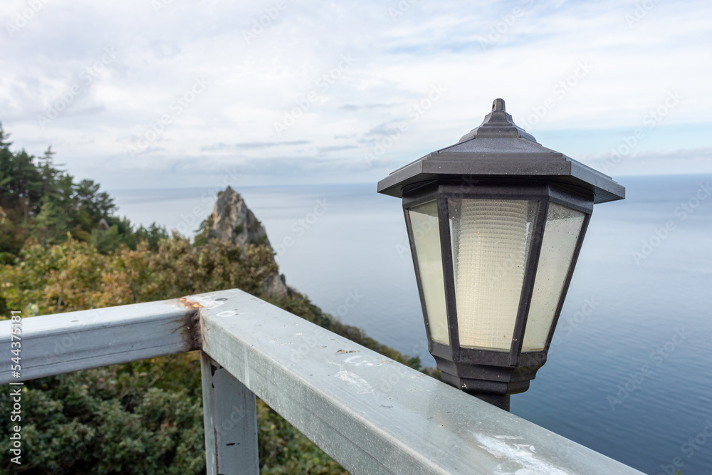Old black lamp light along the rocky cliffs ocean water coastline view in Ulleungdo Island South Korea
