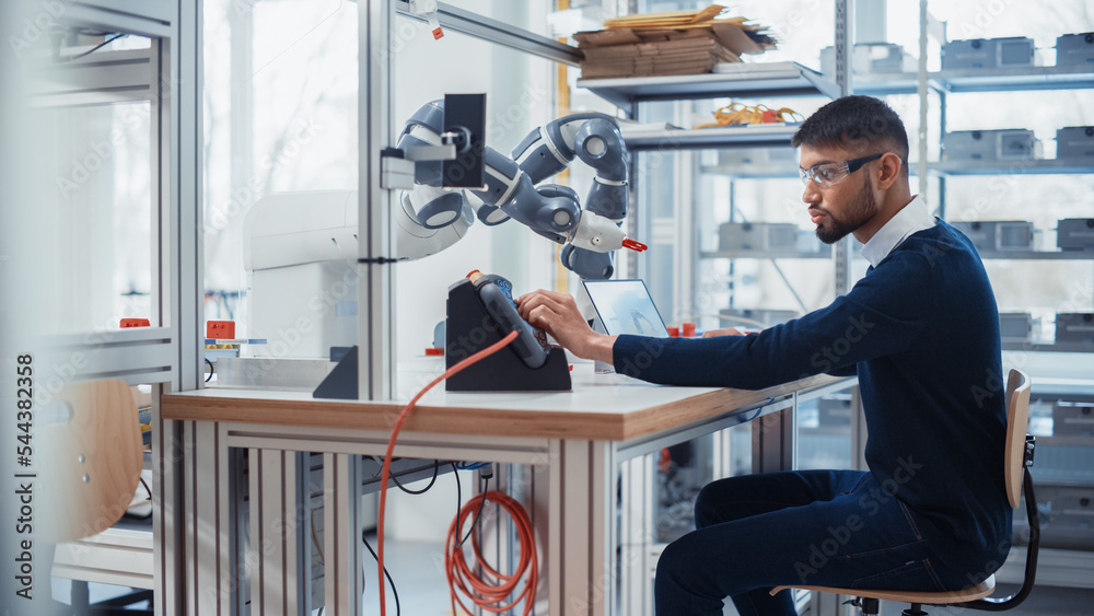 Obraz premium Concentrated Engineer Twist Controllers and Write Code while Developing Program for Autonomous Arm at Robotics Research Center Laboratory. Optimisation and Machine Learning Concept.