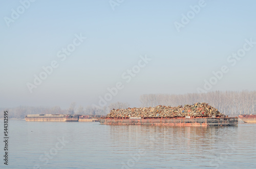 Anchored tankers with waste material. Anchored tankers with loaded waste material on the Danube River.