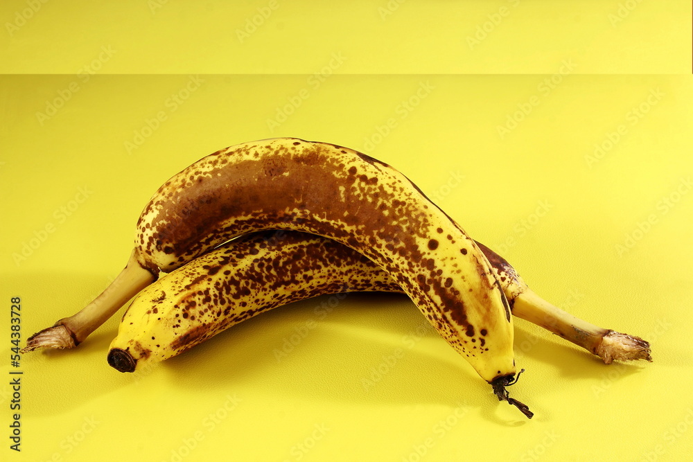 isolated fresh organic over ripe dark brown spots yellow banana fruit on yellow background