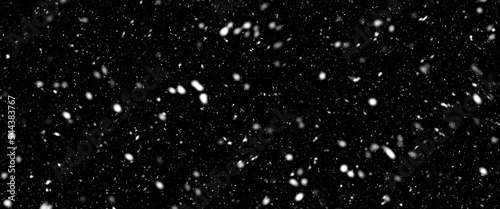 Different realistic falling snow or snowflakes. Falling snow isolated on black background. Winter snowfall illustration. Bokeh lights on black background  flying snowflakes in the air. Snow at night.