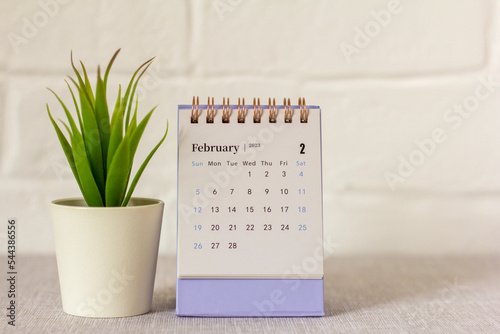 Desktop calendar for February 2023 on a light background.,