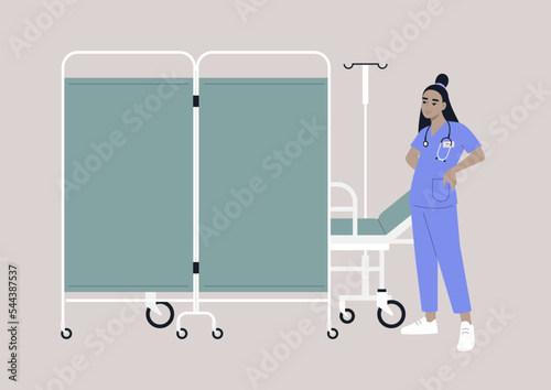 A hospital screen partition on wheels, a medical bed behind a room divider, a young doctor wearing a uniform photo