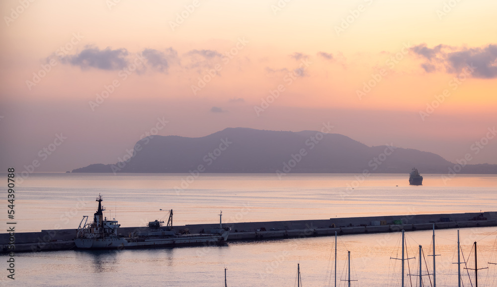 Port in a city with mountain in backgroun in Palermo, Sicily, Italy. Cloudy Sunrise.