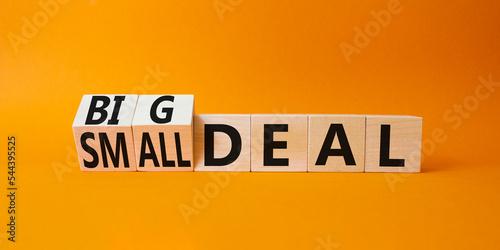 Big deal and small deal symbol. Turned cubes with words Big deal and small deal. Beautiful orange background. Business concept. Copy space