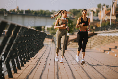 Young woman taking running ...