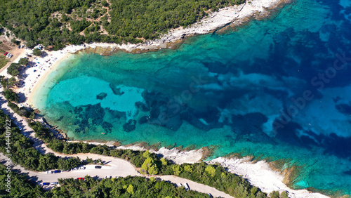 Aerial drone top down photo of tropical exotic paradise secluded rocky bay with deep turquoise sea forming a blue lagoon