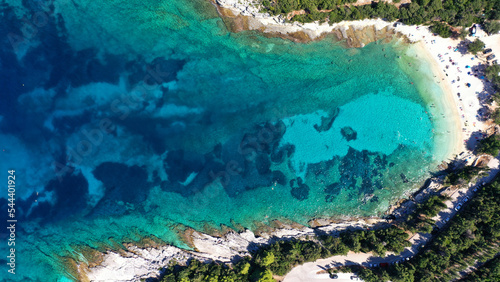 Aerial drone top view photo of exotic paradise beach of Emblisi with turquoise and emerald clear sea near iconic Fiskardo bay, Cefalonia island, Ionian, Greece