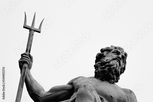 The mighty god of water, sea and oceans Neptune (Poseidon, Triton). Neptun's trident as symbol strength, power and unrestraint. Fragment of an ancient statue. Black and white image. photo