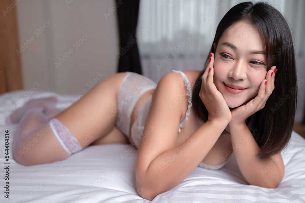 Portrait of asian sexy woman wear white dress in the bedroom Portrait of asian sexy woman wear white dress in the bedroom