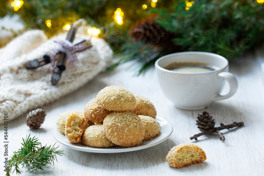 Christmas nut cookies Filbertines served with coffee on a background of Christmas decorations.