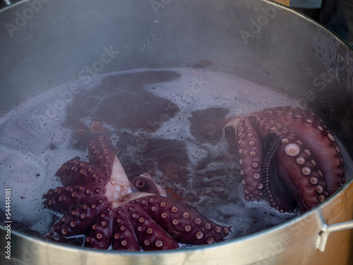 Pulpo a la gallega,galician octopus with potatoes, paprika, salt and olive oil. Typical Spanish Galician tapa, on a traditional wooden plate. Tipical Spanish tapa concept. photo