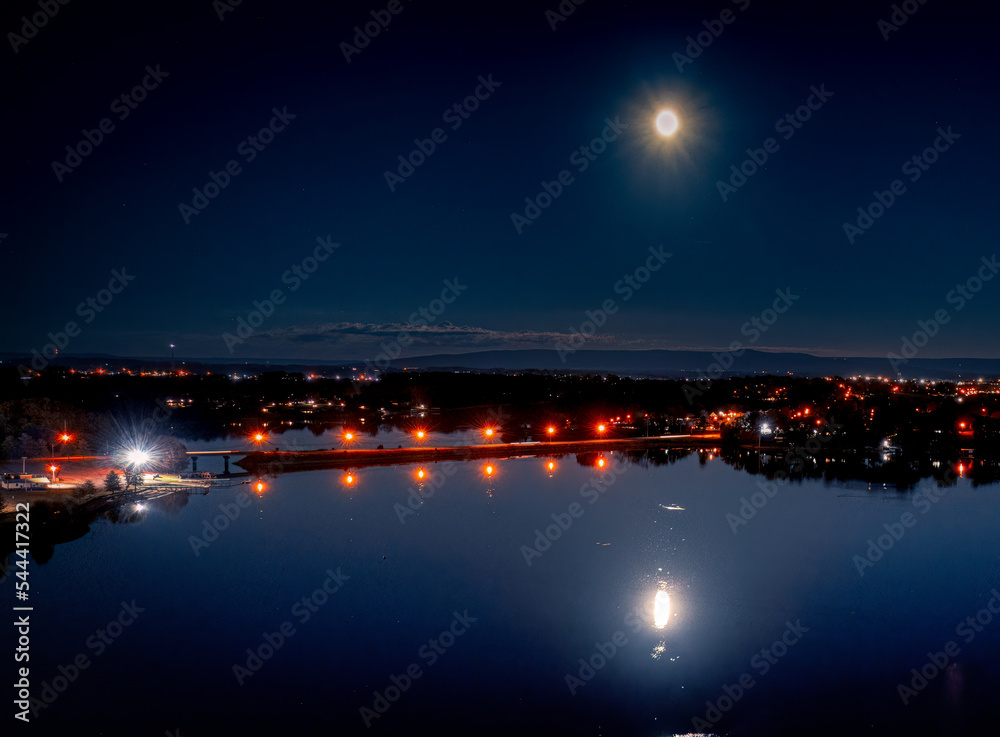 Full moon over the Cumberland Mountains with The Bass Club and bridge in the foreground. Aerial night view on Tims Ford Lake in Winchester Tennessee USA.
